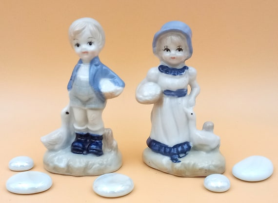 Vintage ceramic boy and girl figurine pair, blue and white, porcelain goose