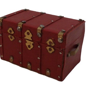 May include: A small red vintage-style suitcase with brass hardware and rivets. The suitcase has a handle on the side and is made of a textured material.