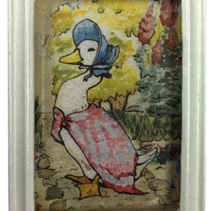 May include: A framed illustration of a duck wearing a blue bonnet and a pink dress. The duck is standing in a garden setting with green trees and yellow flowers.