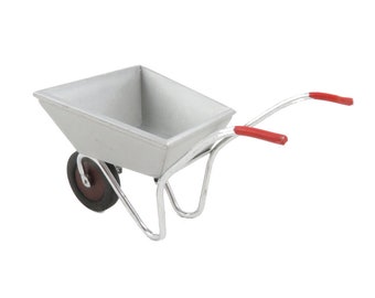 May include: A miniature silver wheelbarrow with red handles. The wheelbarrow is made of metal and has a single wheel.
