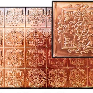 May include: A copper-colored ceiling tile with a decorative embossed pattern. The tile has a square shape and a raised design in the center.