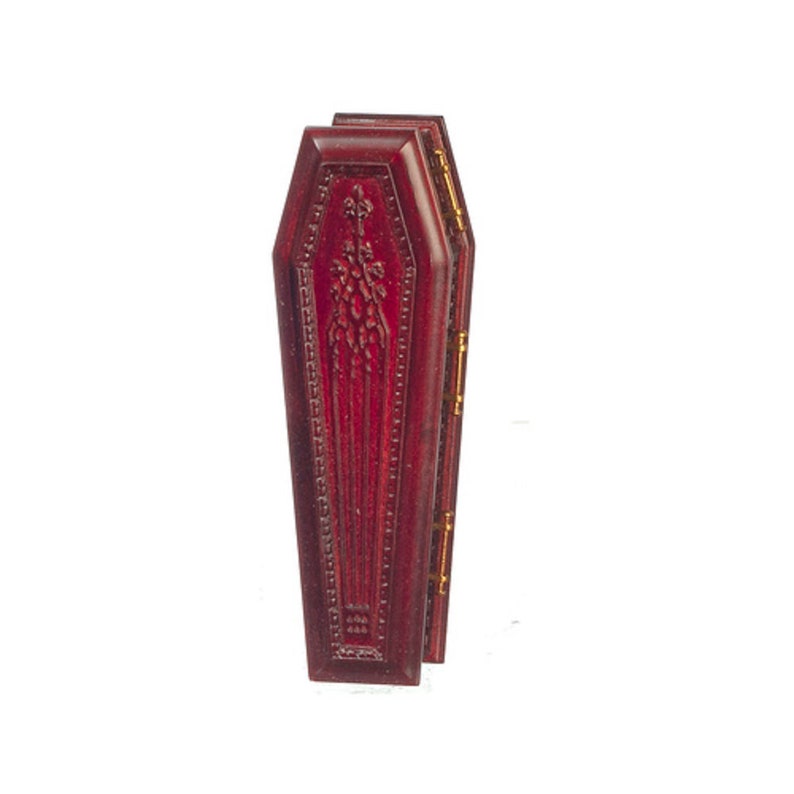 May include: A small, red wooden coffin with gold hinges. The coffin is closed and has a decorative design on the front.