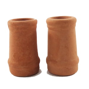 May include: Two terracotta chimney pots, cylindrical in shape, stand side-by-side against a white background. The pots have a flared top and a slightly bulbous base. The color is a warm, earthy orange-brown.