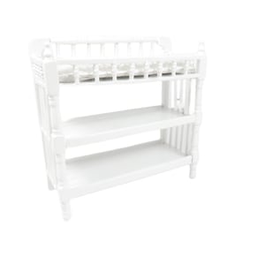 May include: White changing table with three shelves. The top shelf has a white padded changing mat.