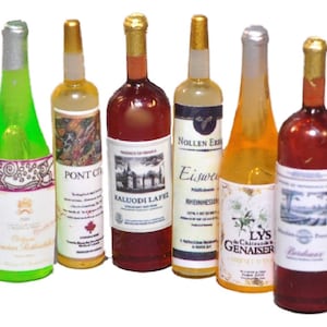 May include: Six miniature glass bottles of wine with various labels. The bottles are all different colors, including green, yellow, red, and white. The labels feature different designs and text, including "Pont City", "Eiswein", and "Kaluodi Lafe".