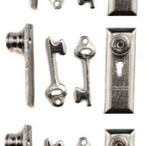 May include: Set of three miniature silver door knobs, each with a keyhole and a matching key. The door knobs are rectangular and have a simple design. The keys are small and have a simple design.