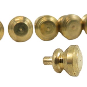 May include: Six gold-toned metal knobs with a rounded top and a threaded base. One knob is shown in a close-up view.