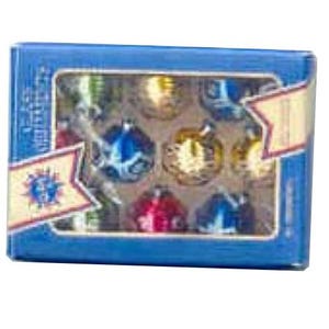 May include: A blue box with a clear window displays a set of small, colorful Christmas ornaments. The ornaments are in various colors, including gold, blue, red, and green. The box has a decorative label with a sunburst design.