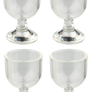 May include: Set of four clear glass goblets with a stemmed base. The goblets are empty and have a classic design.