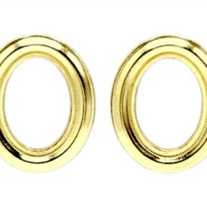 May include: A pair of gold oval-shaped earrings with a decorative border.