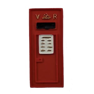 May include: Red vintage style mailbox with a black opening and a white panel with gold accents. The mailbox has the letters "VR" on the top.
