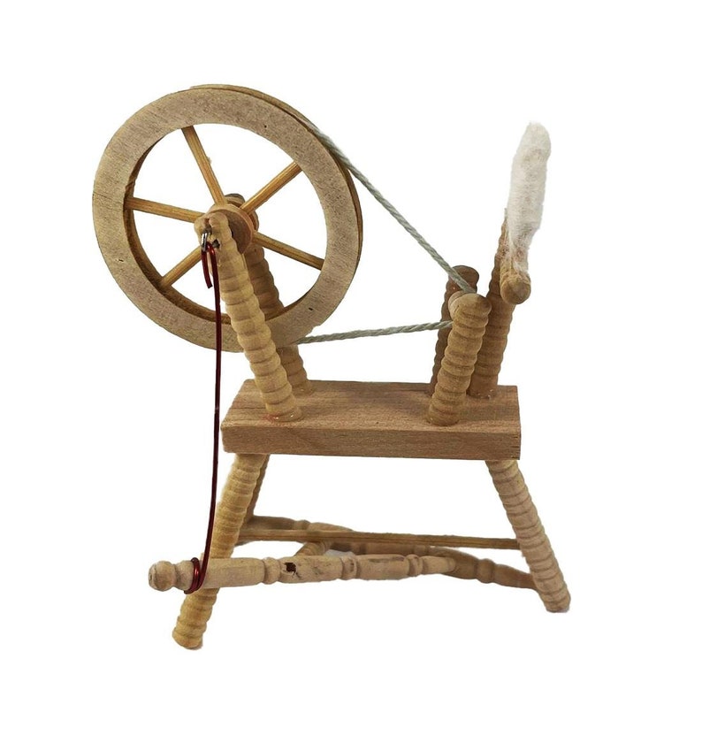 May include: A wooden spinning wheel with a large, round wheel and a spindle. The wheel is made of light wood and has a dark brown finish. The spindle is made of a lighter wood and has a white finish. The spinning wheel is a traditional tool used for making yarn.