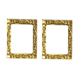 May include: Two gold-colored ornate picture frames with a decorative design. The frames are empty and ready to be used to display photos or artwork.