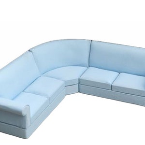 May include: A light blue sectional sofa with a curved back and armrests. The sofa has three cushions on each side and is made of a soft, comfortable fabric.