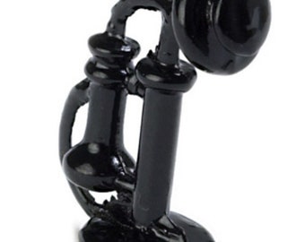 May include: Black rotary dial phone with a black base and a black receiver. The phone is a miniature replica of a vintage phone.