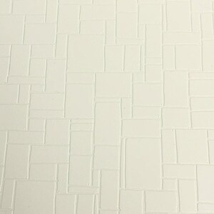 May include: White textured wallpaper with a repeating pattern of squares and rectangles.