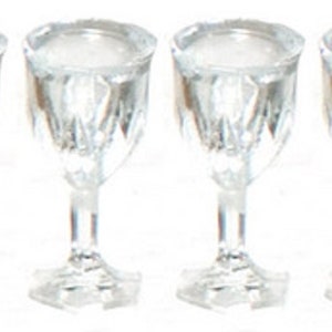 May include: Set of six clear glass wine glasses with a diamond pattern. The glasses are empty and have a stem and a round base.