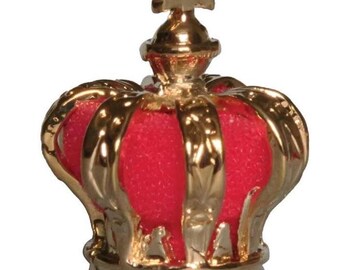 May include: A small, red and gold crown with a cross on top. The crown is made of metal and has a detailed design.