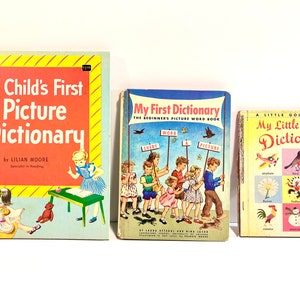 May include: Three vintage children's picture dictionaries. The first book is titled "A Child's First Picture Dictionary" by Lilian Moore. The second book is titled "My First Dictionary" and the third book is titled "My Little Golden Dictionary".