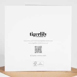 May include: A white greeting card with the text "tigerlily creations" in black. Below the text are website addresses and a QR code. The card is on a brown envelope.