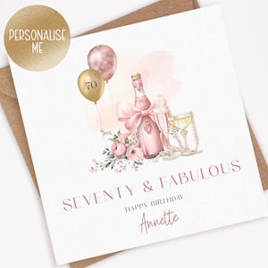 May include: A birthday card with a champagne bottle, two glasses, and floral accents. The card features the text "SEVENTY & FABULOUS" and "HAPPY BIRTHDAY Annette". Two balloons, one gold with the number 70, are also included.