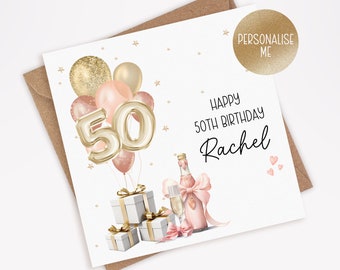 Puede incluir: Una tarjeta blanca con estrellas doradas brillantes y globos rosas y dorados. La tarjeta dice "Feliz cumpleaños número 50 Rachel". Hay una botella de champán y una caja de regalo.