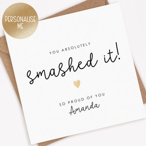 May include: A white card with black text that reads "You absolutely smashed it!" with a gold heart and the text "So proud of you Amanda".
