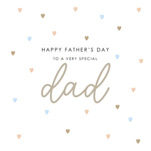 May include: A white card with the text "Happy Father's Day to a very special dad" in brown lettering. The card is decorated with scattered brown and blue hearts.