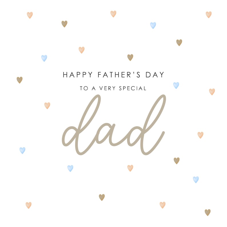 May include: A white card with the text "Happy Father's Day to a very special dad" in brown lettering. The card is decorated with scattered brown and blue hearts.