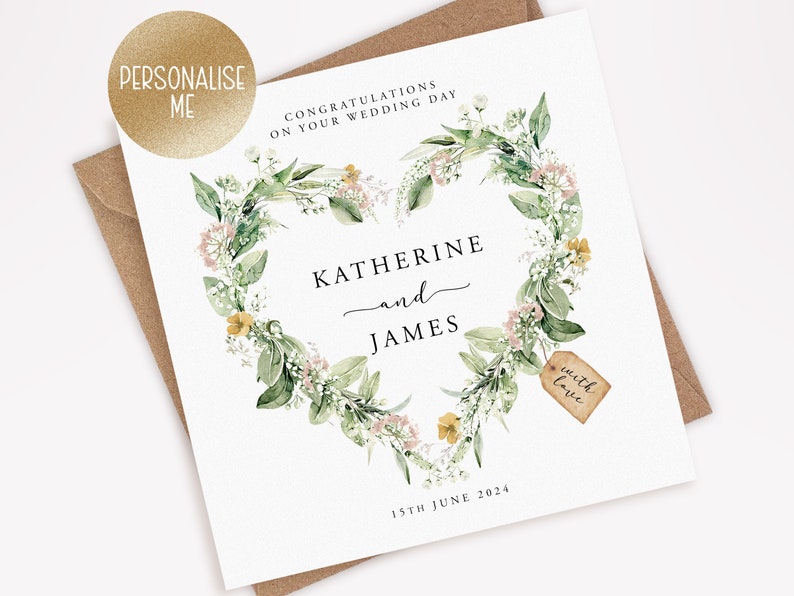 May include: A white wedding card with a floral heart design. The card features the names "Katherine and James" and the date "15th June 2024". The words "Congratulations on your wedding day" are at the top. A small tag reads "with love".