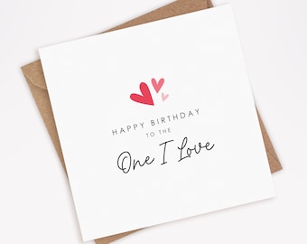 May include: A white card with a pink and red heart design. The card says "Happy Birthday to the One I Love".