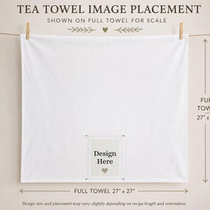 May include: A square white tea towel hanging from a string, featuring a central rectangular area marked with the text 'Design Here' and a small heart icon. The towel measures 68.58 cm by 68.58 cm, as indicated by the text and arrows on the image.