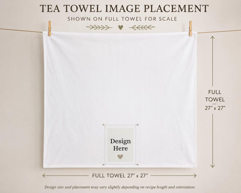 May include: A square white tea towel hanging from a string, featuring a central rectangular area marked with the text 'Design Here' and a small heart icon. The towel measures 68.58 cm by 68.58 cm, as indicated by the text and arrows on the image.