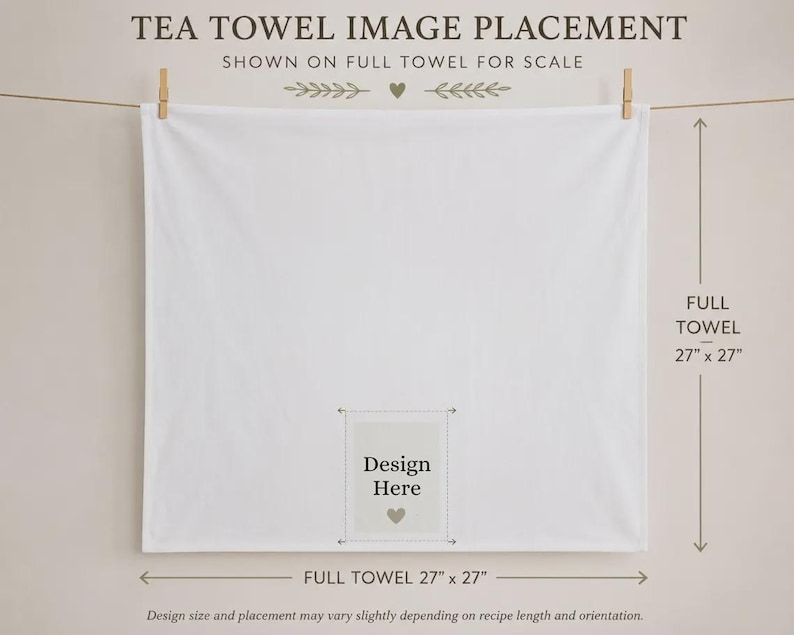 May include: A square white tea towel hanging from a clothesline with two wooden clips. The towel features a central rectangular area labeled Design Here with a small heart icon. Text indicates the full towel measures 27 inches by 27 inches.