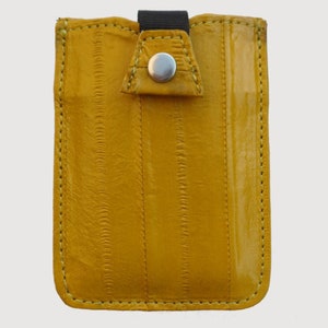 May include: A yellow leather phone case with a textured surface and a snap closure.