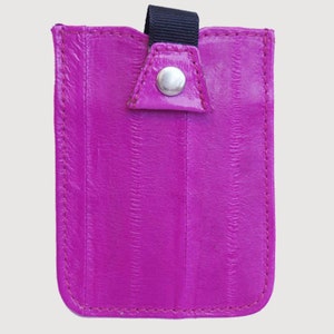May include: A small, bright pink leather card holder with a black strap and a silver button closure.