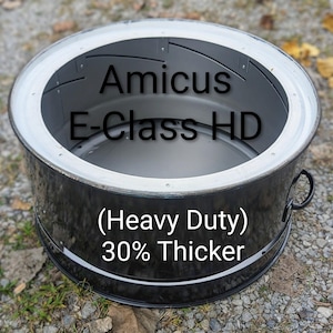 May include: A black and silver metal container with the text "Amicus E-Class HD (Heavy Duty) 30% Thicker." The container has a circular shape with a silver rim and two black handles.