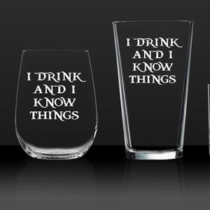May include: Set of four clear glass drinking glasses with the phrase "I drink and I know things" etched on each. The glasses are different sizes and shapes.