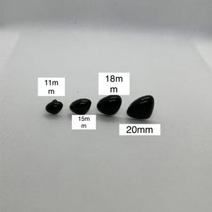 May include: Four black plastic safety eyes in different sizes: 11mm, 15mm, 18mm, and 20mm. These eyes are commonly used for plush toy making and craft projects.
