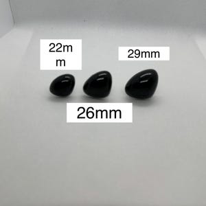 May include: Three black plastic safety eyes for crafts, measuring 22mm, 26mm, and 29mm.