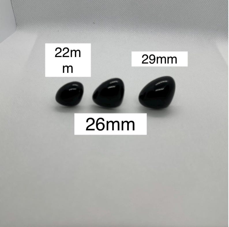 May include: Three black plastic safety eyes for crafts, measuring 22mm, 26mm, and 29mm.