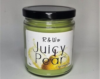 May include: A green glass jar candle with a black lid. The label says "R&W co Juicy Pear" and has a picture of a pear with a splash of liquid.