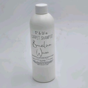 May include: White bottle of R & W Co. carpet shampoo, labeled "Brazilian Waves." The bottle has a white cap and a white label with black text. The label includes the brand name, product name, and instructions. The website RWCOSHOP.COM is also visible.