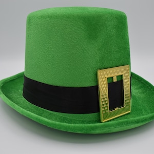 May include: A green felt top hat with a black band and a gold buckle. The hat is a traditional Irish leprechaun hat.