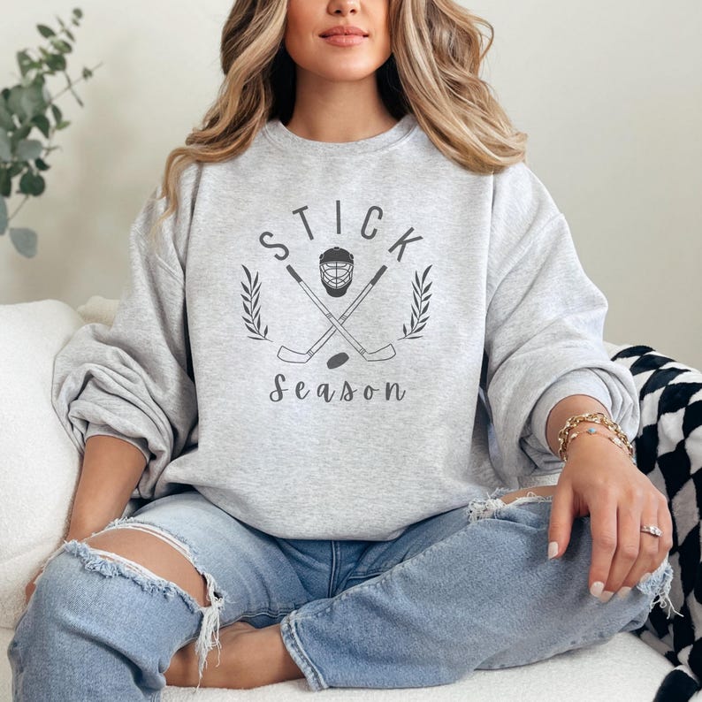 May include: A gray sweatshirt with the text "STICK season" and a hockey stick and mask graphic.