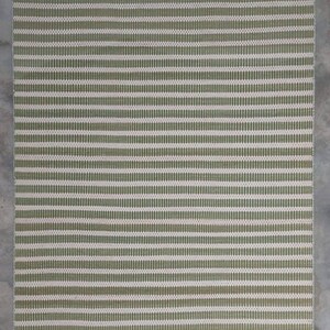 May include: A green and white striped woven rug with a subtle texture. The rug has a rectangular shape and is made of natural fibers.