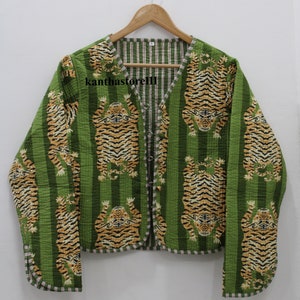 May include: A green quilted jacket with a striped pattern and a tiger print. The jacket has a button closure and long sleeves.
