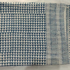 May include: A blue and white kantha quilt with a geometric pattern. The quilt is made of cotton and is hand-stitched. It is a traditional Indian textile.