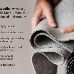 May include: A close-up of a gray wool felt fabric, folded in a hand. The text reads: "At Woolberry we use 100% Merino Wool Felt produced in Germany."  The text below the image lists the following features: highly durable, pleasant to the touch, naturally repels soiling and moisture, highly saturated and lightfast colors, resistance to compression, biodegradable.