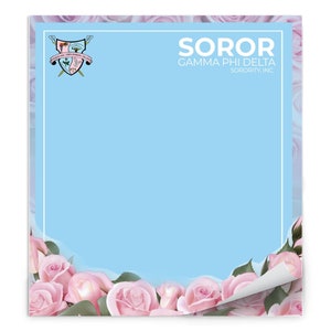 May include: A light blue notepad with the text "SOROR GAMMA PHI DELTA SORORITY, INC." and a crest. The notepad is framed with a white border and a floral design of pink roses.